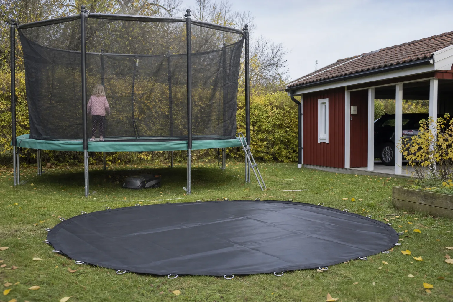 Svart hoppduk utbredd på gräs med sömmar och kantöglor synliga