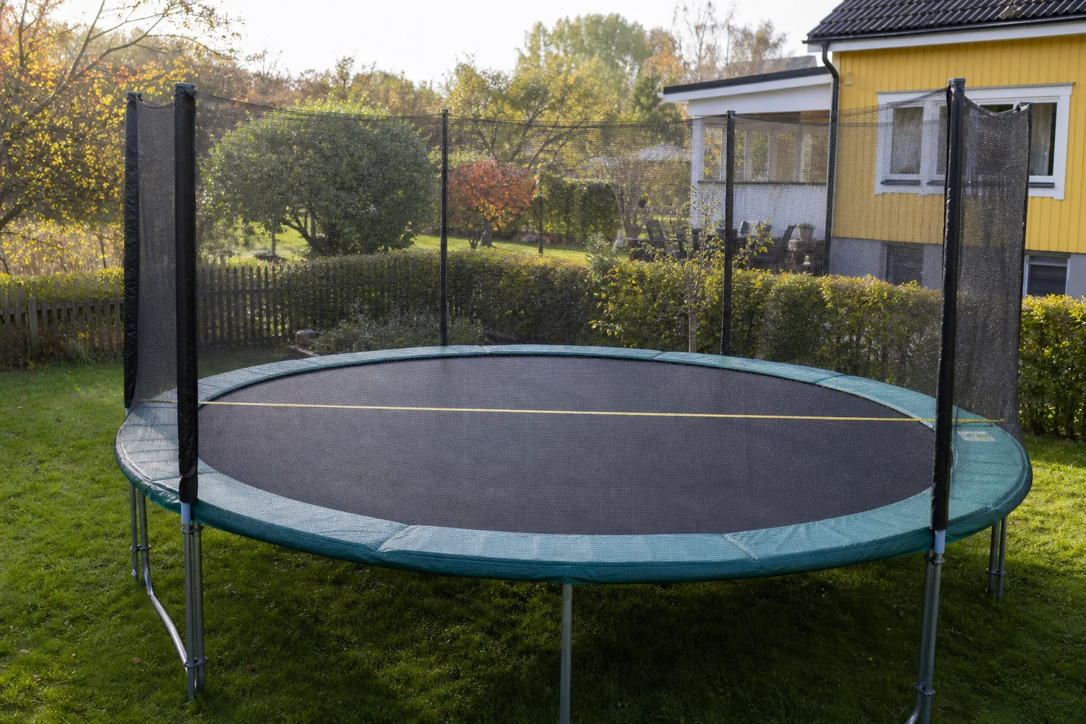 Ett måttband sträckt över en rund studsmattas stålram